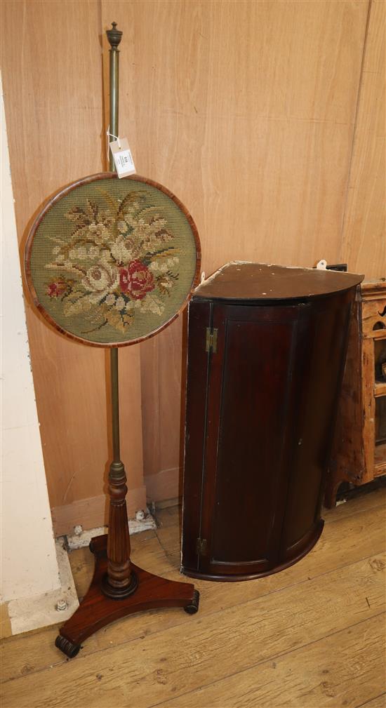 A mahogany bowfront hanging corner cabinet and a Regency polescreen W.57cm and 36cm